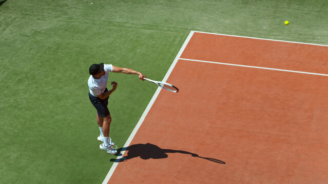 Freeze motion shot of tennis player hitting the ball