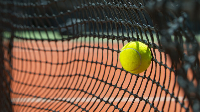 Freeze motion shot of tennis ball hitting the net