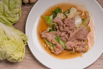 Stir Fried Cabbage with Pork in a White Plate