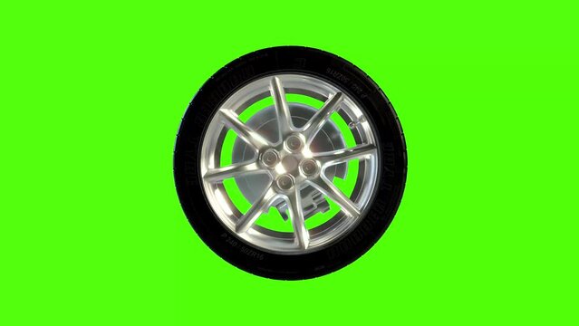 Side on view of a 3D wheel rolling across the screen. Standard black, rubber tyre and wheel rim in a continuous spin. Footage with a green screen for isolating the object.