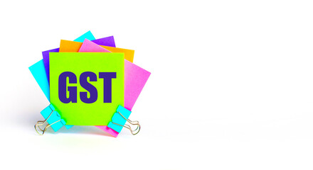 There are bright multi-colored stickers with the text GST Goods and Services Tax. Copy space