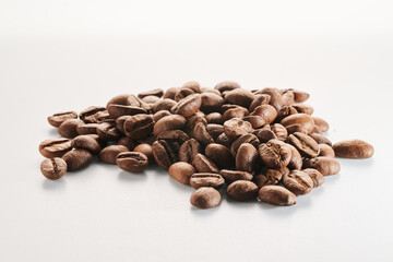 Roasted coffee beans isolated close up on white background, clipping path