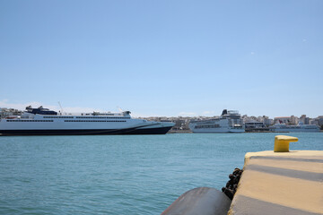 Modern cruise ship and ferry in sea port on sunny day