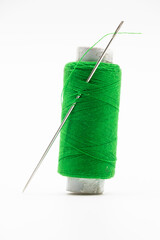 green yarn or spool thread over on white background