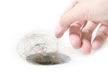 Water drain is clogged with hair. Hair fall disease. Female pattern baldness or alopecia. Hair loss...