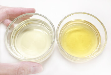 Urine samples in medical glassware. Light yellow (good) and yellow (light dehydrated) urine samples in petri dishes. Medical urine test. Analysis and research in medical laboratory. Healthcare concept