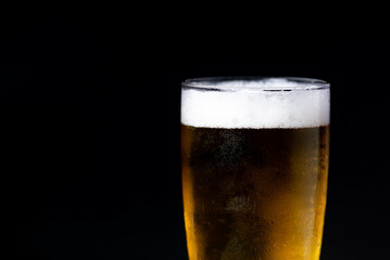 glass of beer on dark background