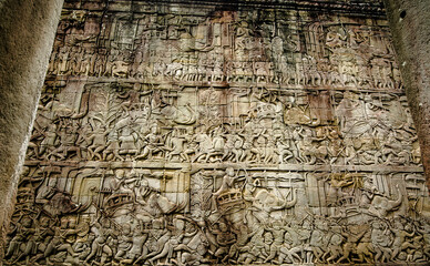 The sandstone bas-reliefs tell the stories of armies and wars. On the wall of Siem Reap Bayon Temple, Cambodia