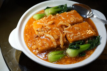 Deep fried tofu with braised crabmeat thick sauce. Traditional Chinese food.