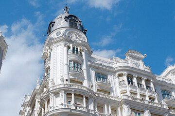 Corner of elegant old building with rounded forms in balconies and structure in centre of Madrid, Spain. Stunning Spanish architectural style