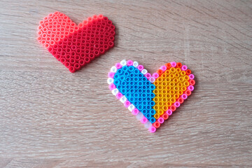 close-up of blue yellow heart, creating perler bead patterns, make flag of ukraine using thermomosaic technique, perler bead art, development of fine motor skills, thermo mosaic ideas