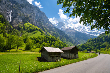 Fototapeta na wymiar amazing alpine valley with wooden huts and road in Lauterbrunnen in Switzerland