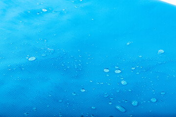 Water repellent fabric, waterdrops on blue waterproof surface