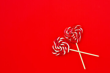heart-shaped lozenges on a red background valentine's day holiday place for text