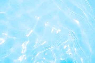 Blurred transparent blue colored clear calm water surface texture with splashes and bubbles. Trendy abstract nature background. Water waves in sunlight. water background
