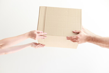 cardboard craft box delivery in hands bottom view