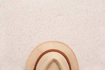Fototapeta na wymiar Summer minimalist mockup / template on a sand background with straw hat and sand. Tropical vacation concept.