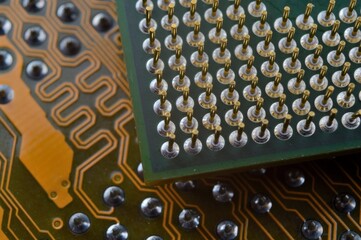 microprocessor on the background of the microcircuit of the motherboard