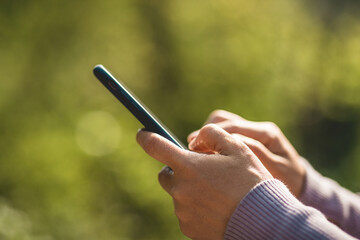 Asian woman using smartphone outdoors