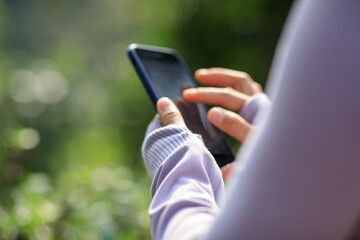 Asian woman using smartphone outdoors