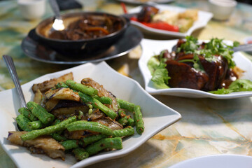Selective focus image of stir fried of eggplant, long bean with dried shrimp. Traditional Chinese home cook food.