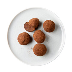 Homemade chocolate cheese truffles on gray plate isolated on white background. Top view. Delicious chocolate candies.