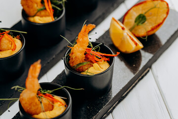 Fried tiger shrimps in breadcrumbs served with mango sauce ready for furshet in restaurant. Seafood, shellfish
