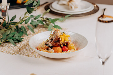 Meat roll with prunes is served on a pillow of vegetables and rice in restaurant