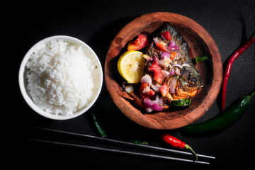 fried pomfret with herbs and rice bowl. good for kitchen poster and wallpaper