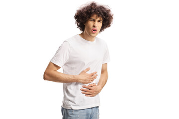 Casual young man experiencing abdominal pain and holding his belly