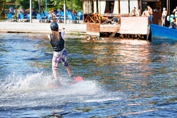Wakeboarding competition on a summer day. The athlete goes to the start.