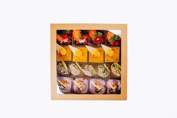 Different portions of desserts with jelly and fruit in a box are ready for delivery