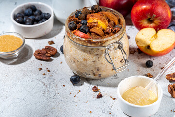 Healthy vegan dietary breakfast or snack. Apple pie overnight oatmeal, oats flakes with apples,...