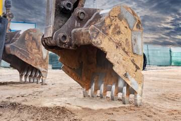 Close up of excavator bucket at construction site. Construction equipment for earthworks.