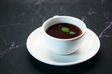 dark chocolate cream in a coffee cup on table 