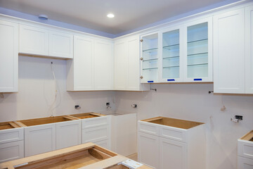 Assembly and installation of modern kitchen cabinets on new house