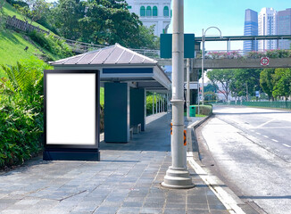 Blank vertical advertising poster banner mockup at bus stop shelter by main road, at city centre;...
