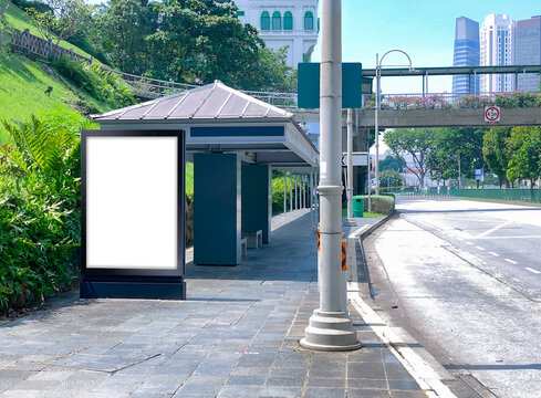 Blank vertical advertising poster banner mockup at bus stop shelter by main road, at city centre; out-of-home OOH billboard media display space. clarke quay area.