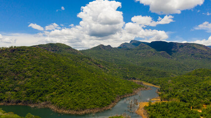 Tropical landscape: mountains and jungle hills with lake. Kalu Ganga Reservoir, Sri Lanka.