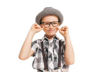 Portrait of cute little boy, happy kid in eyeglasses and hat isolated on white studio background with copyspace for ad. Retro vintage style concept