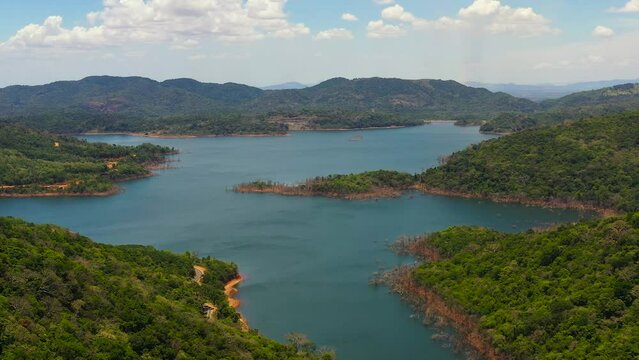 A beautiful lake among the mountains with a green forest. Kalu Ganga Reservoir, Sri Lanka.