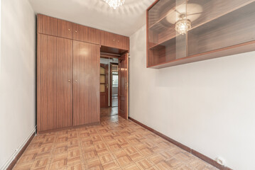 Bedroom with deck covered in built-in wooden wardrobes with matching trunks