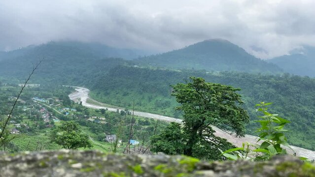 Timelapse video of India Bhutan border at Jhalong , Dooars - West Bengal , India. Serene landscape and clouds moving at Bhutan mountains.
