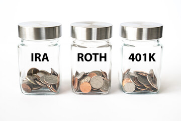Jars with coins for retirement savings in Roth, 401K and IRA accounts
