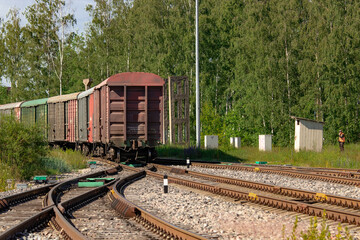 railway in the countryside,railway fork, a locomotive with a wagon and a red semaphore