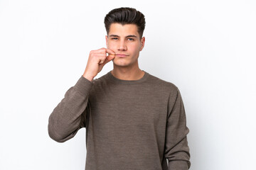 Young handsome caucasian man isolated on white bakcground showing a sign of silence gesture