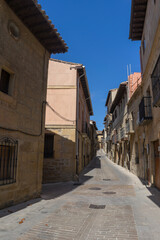 Fototapeta na wymiar Walking through narrow streets with blue sky in Tafalla, Navarra, Spain, Sapin