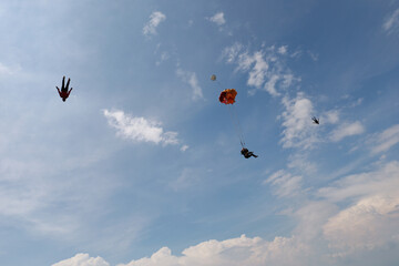 Skydiving. Skydivers are flying in the sky.