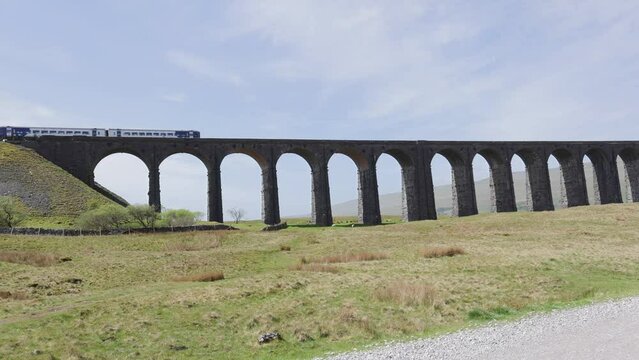 Train crossing Ribblehead Viaduct or Batty Moss on a sunny day