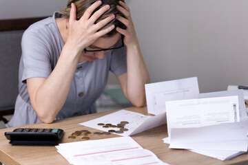 A woman, surrounded by receipts and steths